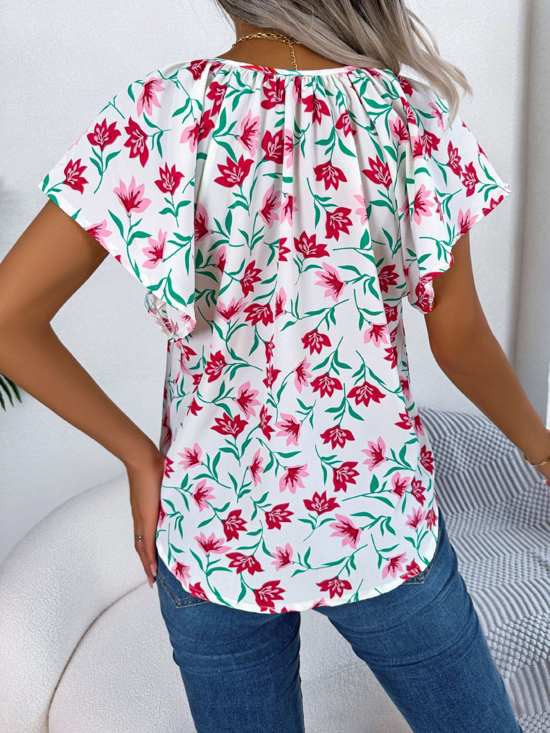 Blusa floral con cuello anudado y mangas acampanadas