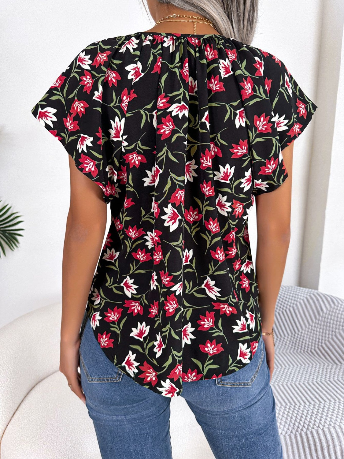 Blusa floral con cuello anudado y mangas acampanadas